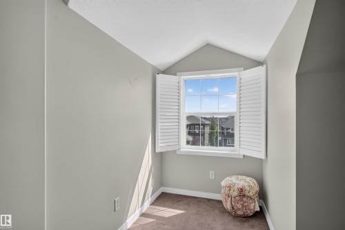 Window with white plantation shutters, neutral wall paint, and brown carpet flooring - 4471 Mccrae Avenue Nw, Edmonton, AB - Indoor Photo Showing Other Room
