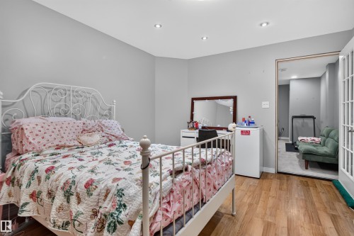 Wood-finish flooring with recessed lighting - 4471 Mccrae Avenue Nw, Edmonton, AB - Indoor Photo Showing Bedroom