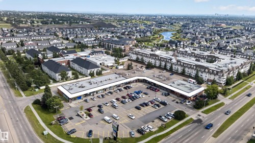 Neighborhood featuring a commercial center, residential buildings, and a pond - 4471 Mccrae Avenue Nw, Edmonton, AB -  With View