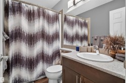 Recessed lighting, wood-finish flooring, and light-toned walls - 
