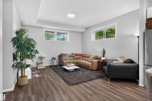 Recessed lighting, wood-finish flooring, and white trim - #34 6520 2 Av Sw, Edmonton, AB - Indoor Photo Showing Living Room
