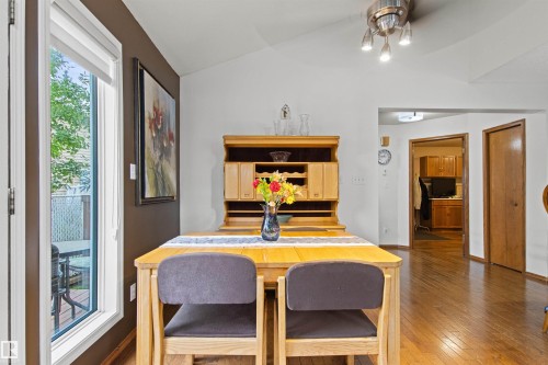 Vaulted ceilings, wood-finish flooring, and a built-in hutch - 11139 157 Avenue Nw, Edmonton, AB - Indoor Photo Showing Dining Room