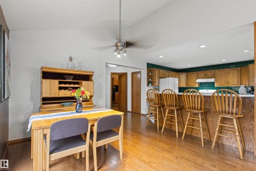 Wood-finish flooring throughout, with a recessed lighting kitchen and wood cabinetry - 11139 157 Avenue Nw, Edmonton, AB - Indoor Photo Showing Dining Room