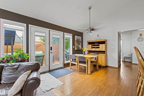 Hardwood flooring throughout, with a built-in wood hutch, and multiple French doors - 11139 157 Avenue Nw, Edmonton, AB - Indoor