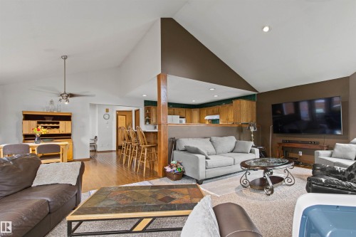 Vaulted ceilings, recessed lighting, wood-finish flooring, wood cabinetry, and a ceiling fan - 11139 157 Avenue Nw, Edmonton, AB - Indoor Photo Showing Living Room