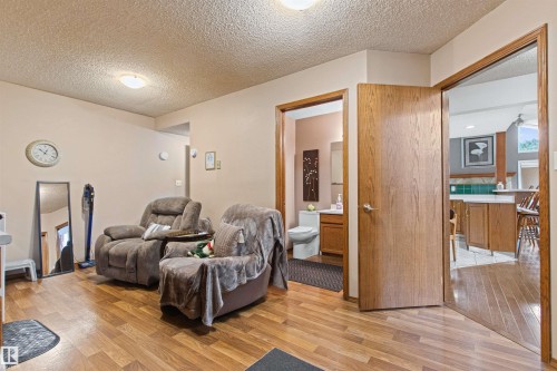 Wood-finish flooring throughout, light neutral wall tones, and recessed ceiling lighting - 11139 157 Avenue Nw, Edmonton, AB - Indoor