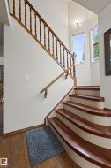 Curved staircase with wood-finish treads and white risers - 