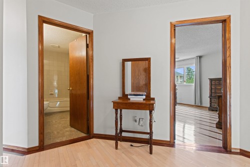 Light wood-finish flooring throughout, featuring natural wood trim and solid core doors - 11139 157 Avenue Nw, Edmonton, AB - Indoor Photo Showing Other Room