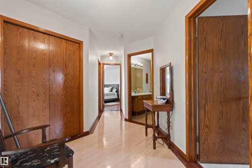 Hardwood flooring, wood-finish doors, wood-finish trim, and a ceiling-mounted light fixture - 11139 157 Avenue Nw, Edmonton, AB - Indoor Photo Showing Other Room