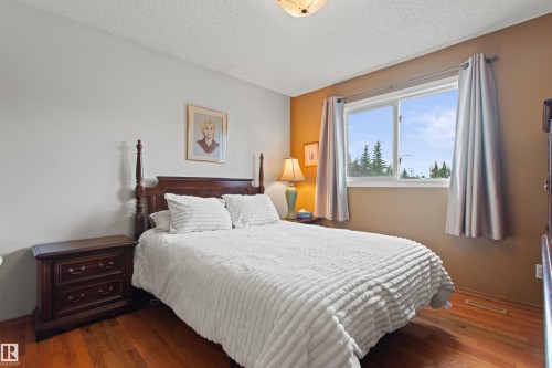 Hardwood-finish flooring, a double window with curtain rods, and a ceiling light fixture - 11139 157 Avenue Nw, Edmonton, AB - Indoor Photo Showing Bedroom