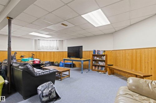 Carpeted flooring, wood paneling, white walls, drop ceiling, and recessed lighting - 11139 157 Avenue Nw, Edmonton, AB - Indoor
