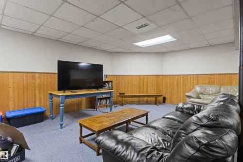 Recessed lighting, wood-finish paneling, and wall-to-wall carpeting - 11139 157 Avenue Nw, Edmonton, AB - Indoor Photo Showing Basement