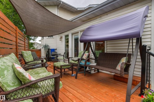 Expansive wooden deck featuring privacy fencing, a sunshade, and a white siding exterior - 11139 157 Avenue Nw, Edmonton, AB - Outdoor With Deck Patio Veranda With Exterior