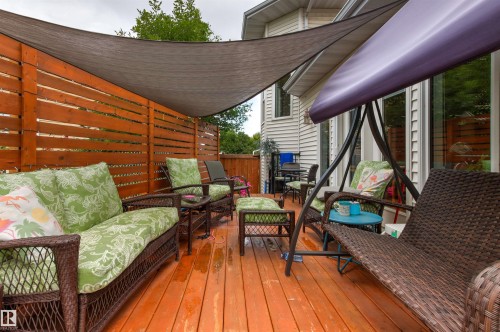 Expansive outdoor deck featuring wood flooring, a slatted privacy fence, and a shade sail - 11139 157 Avenue Nw, Edmonton, AB - Outdoor With Deck Patio Veranda With Exterior