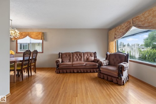Hardwood flooring, large picture window, additional window, built-in lighting fixture, neutral wall color - 8411 136 Avenue Nw, Edmonton, AB - Indoor Photo Showing Living Room