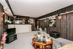 Interior space featuring wood-finish paneling and light-colored carpeting - 