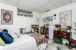 White walls offer a neutral canvas in this room featuring a window with natural light, a drop ceiling, and a built-in wall sconce - 