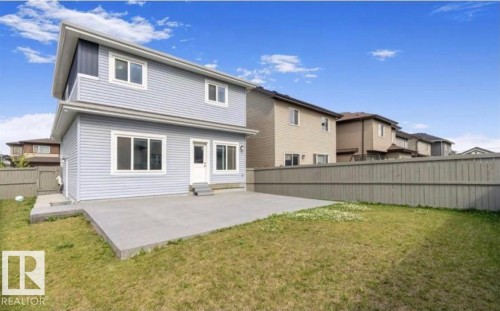 Rear elevation featuring light blue horizontal siding and multiple windows - 1103 29 Street Nw, Edmonton, AB - Outdoor