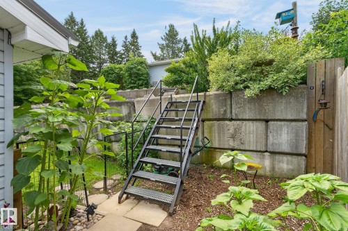 Tiered retaining walls with integrated metal staircase and handrails - 351 Smith Crescent, Rural Parkland County, AB - Outdoor