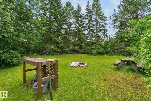 Expansive lawn area, mature trees, and a fire pit feature - 351 Smith Crescent, Rural Parkland County, AB - Outdoor