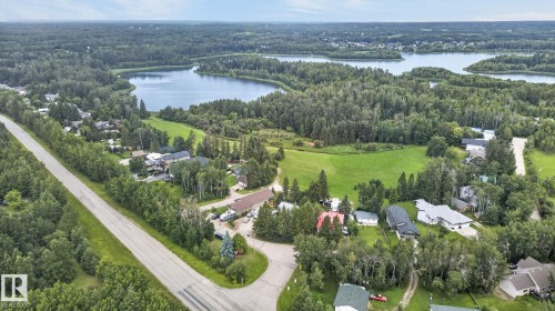 Expansive natural landscape featuring a prominent body of water, dense tree cover, and a paved road - 351 Smith Crescent, Rural Parkland County, AB - Outdoor With Body Of Water With View