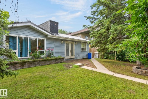 Siding exterior with a black brick chimney, dual French doors, and an elongated window - 351 Smith Crescent, Rural Parkland County, AB - Outdoor