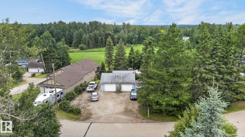 Property featuring mature trees and a multi-unit dwelling with a brown shingle roof - 351 Smith Crescent, Rural Parkland County, AB - Outdoor With View