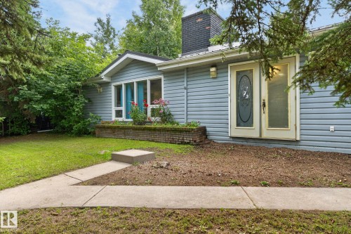 Light blue siding exterior with a prominent brick chimney - 351 Smith Crescent, Rural Parkland County, AB - Outdoor