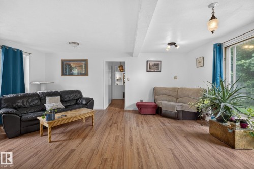 White walls with wood-finish flooring, recessed lighting, and a sliding glass door - 351 Smith Crescent, Rural Parkland County, AB - Indoor Photo Showing Living Room