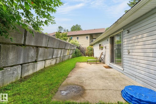 Concrete patio area with direct access to interior via sliding glass door - 351 Smith Crescent, Rural Parkland County, AB - Outdoor With Exterior