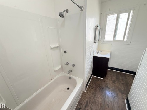 White fiberglass shower surround with integrated shelving and chrome fixtures - 10416 100 Avenue, Westlock, AB - Indoor Photo Showing Bathroom