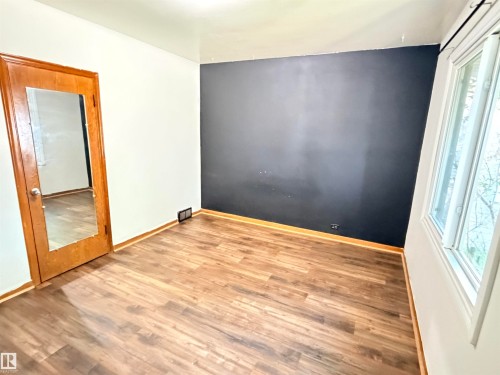 Wood-finish flooring, white walls, and a single window - 10416 100 Avenue, Westlock, AB - Indoor Photo Showing Other Room