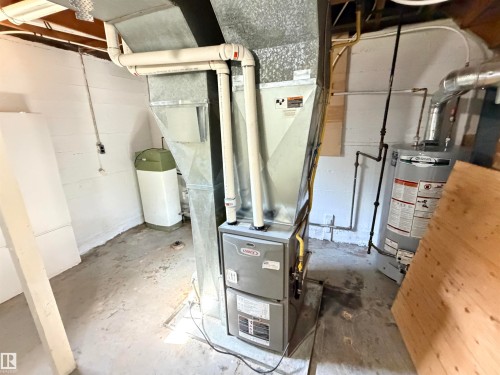 Lennox furnace, natural gas piping, galvanized ductwork, PVC plumbing, and a water heater - 10416 100 Avenue, Westlock, AB - Indoor Photo Showing Basement