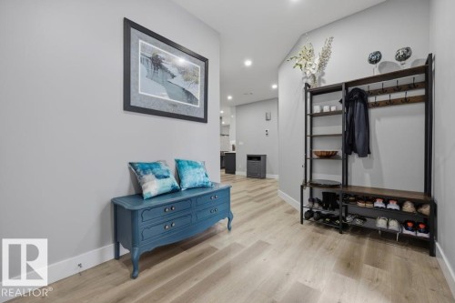 Recessed lighting illuminates the wood-finish flooring and light gray walls - 3303 Soleil Boulevard, Beaumont, AB - Indoor Photo Showing Other Room