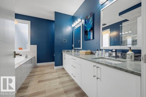 Dual vanity with undermount sinks, stone countertops, and ample storage cabinetry - 3303 Soleil Boulevard, Beaumont, AB - Indoor Photo Showing Bathroom