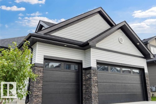 Two-car garage with stacked stone accents - 3303 Soleil Boulevard, Beaumont, AB - Outdoor