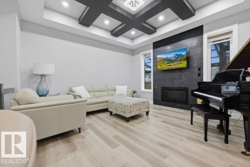 Recessed lighting, light wood-finish flooring, and a coffered ceiling - 3303 Soleil Boulevard, Beaumont, AB - Indoor With Fireplace