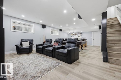 Recessed lighting, wood-finish flooring, staircase with wood treads, and built-in bar with open shelving - 3303 Soleil Boulevard, Beaumont, AB - Indoor