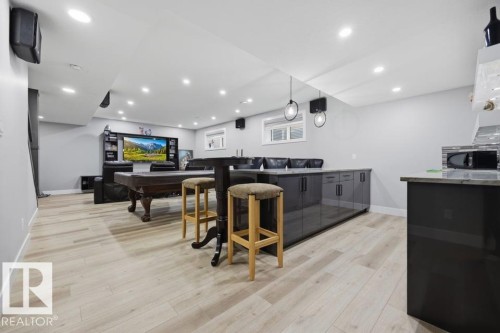 Recessed lighting illuminates the open-concept space featuring light wood-finish flooring - 3303 Soleil Boulevard, Beaumont, AB - Indoor