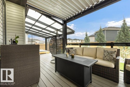 Covered outdoor deck with composite flooring, a translucent roof, and clear panel railings - 3303 Soleil Boulevard, Beaumont, AB - Outdoor With Deck Patio Veranda With Exterior