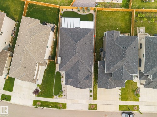 Pitched rooflines, concrete driveway, and a fenced backyard with artificial turf - 3303 Soleil Boulevard, Beaumont, AB - Other