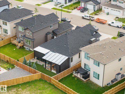 Landscaped backyard with covered patio, artificial turf, and privacy fencing - 3303 Soleil Boulevard, Beaumont, AB - Outdoor