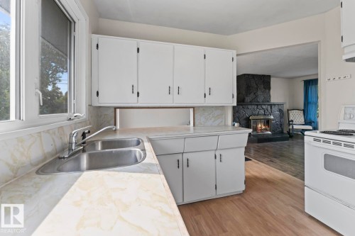 5105 58 Street, Cold Lake, AB - Indoor Photo Showing Kitchen With Fireplace With Double Sink