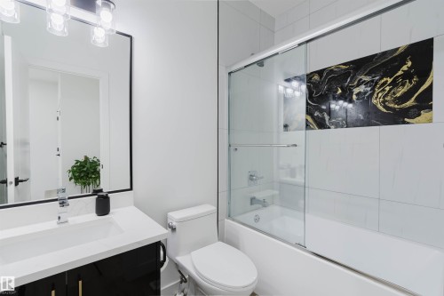 Bathroom featuring a vanity with a white countertop, a rectangular sink, and a black framed mirror - 5320 Kimball Place Sw, Edmonton, AB - Indoor Photo Showing Bathroom