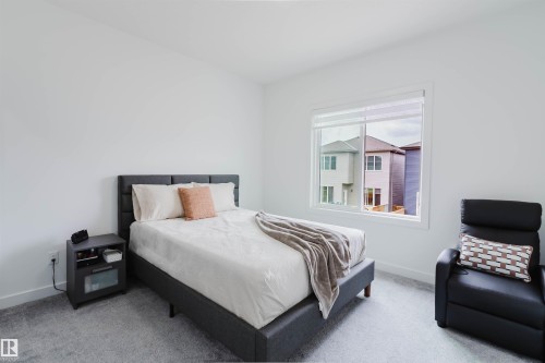 Crisp white walls, plush carpeting, and a large window with white framing - 5320 Kimball Place Sw, Edmonton, AB - Indoor Photo Showing Bedroom