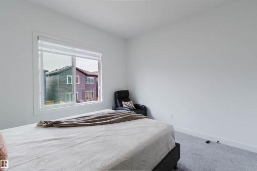 Light grey wall-to-wall carpeting, white walls, and a large window with white trim - 5320 Kimball Place Sw, Edmonton, AB - Indoor Photo Showing Bedroom