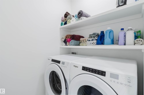 Built-in shelving with white finish - 5320 Kimball Place Sw, Edmonton, AB - Indoor Photo Showing Laundry Room