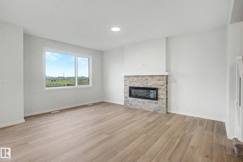 5435 Hawthorn Run Sw, Edmonton, AB - Indoor Photo Showing Living Room With Fireplace