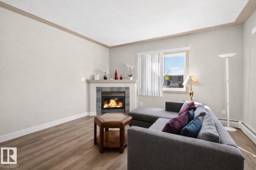 #101 4415 48 St, Leduc, AB - Indoor Photo Showing Living Room With Fireplace