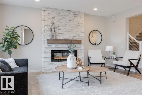113 Stiles Bend, Leduc, AB - Indoor Photo Showing Living Room With Fireplace